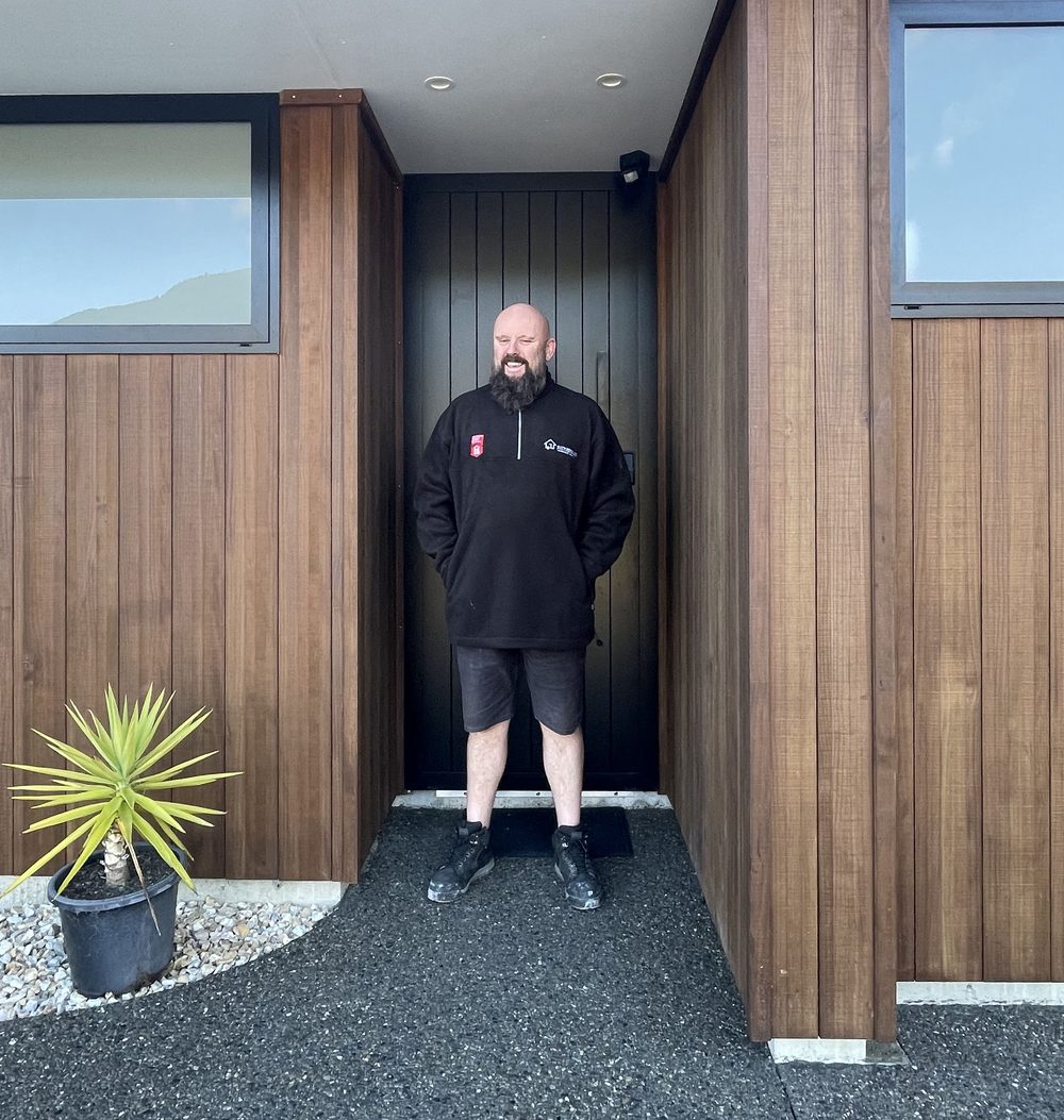 Completed Nelson home with cedar cladding and a black front door