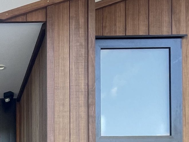 Cedar cladding meeting black aluminium joinery on a Nelson home