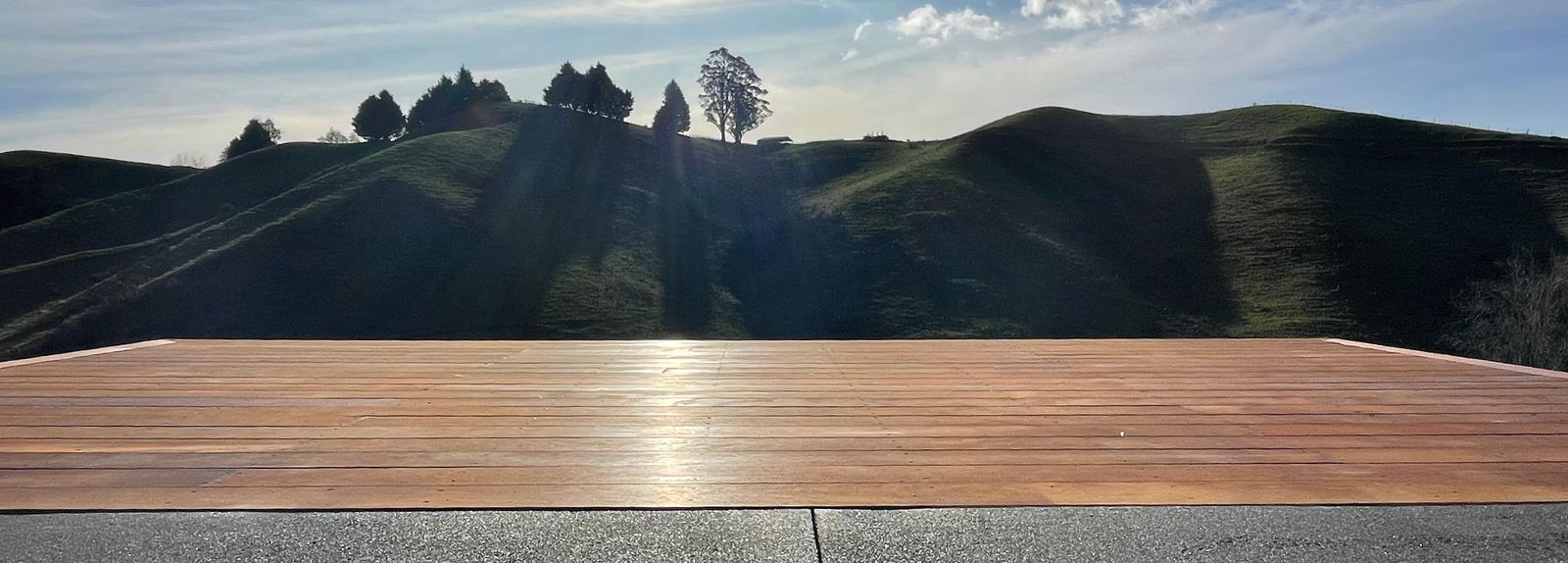 Wide hardwood deck looking out over Nelson hill country