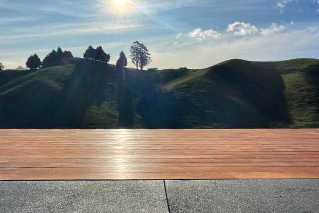 Timber deck catching late afternoon sun above Nelson hill country